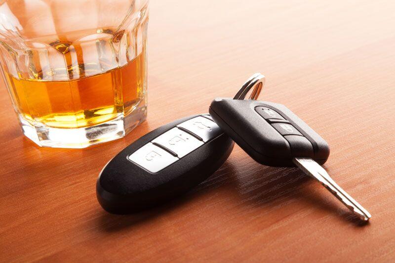 car keys next to glass of alcohol